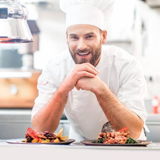 hire-a-chef smiling chef in kitchen