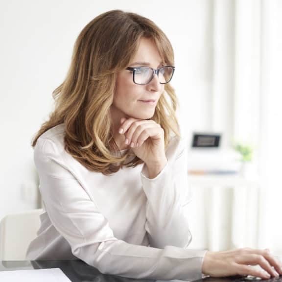 5 Things to Consider Before Hiring a Nanny Housekeeper Agency vs Yourself lady working at laptop