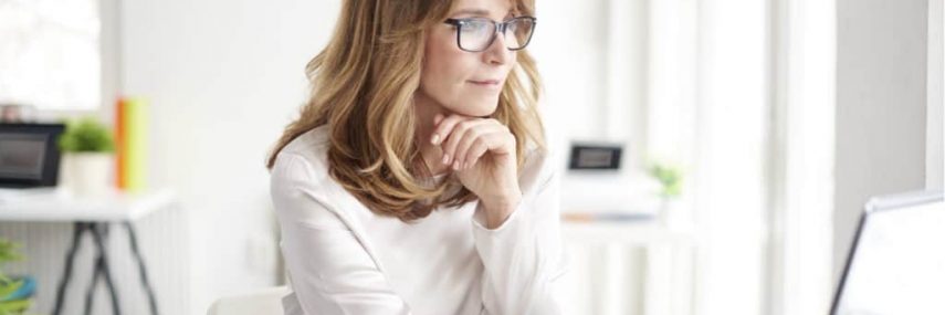 5 Things to Consider Before Hiring a Nanny Housekeeper Agency vs Yourself lady working at laptop