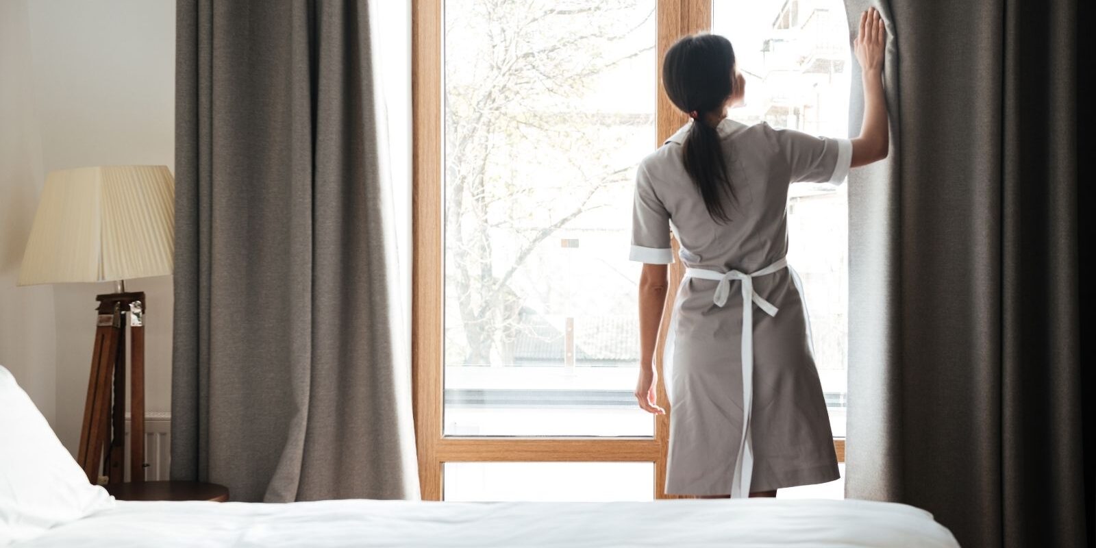 housekeeper cleaning windows