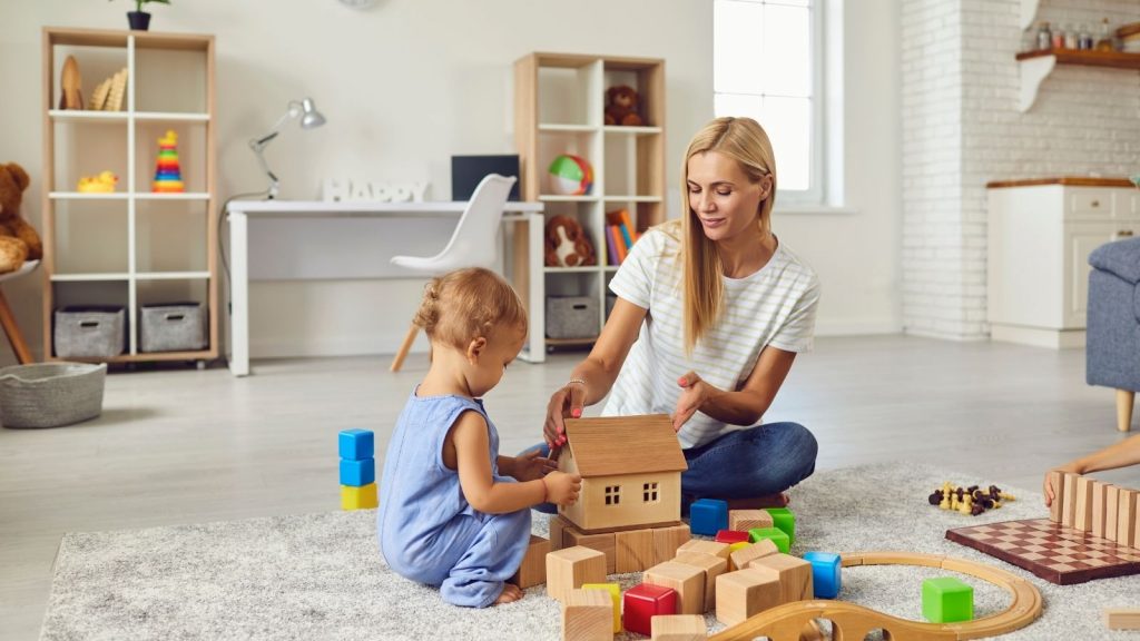 Happy nanny playing with children