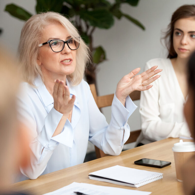 Aged businesswoman, teacher or business coach speaking to young people Recruitemnt